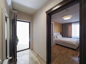 A hotel room with a bed, bedside table, and a view of the outside. - Boutique Central Sibiu (Sibiu)