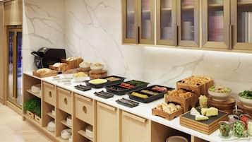 A buffet setup with various food items and serving dishes.