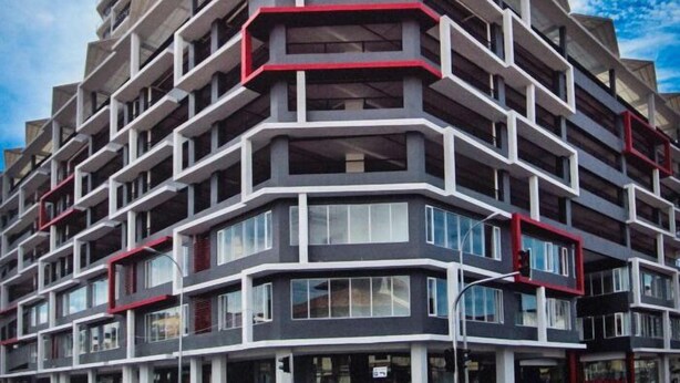 A multi-story hotel with a modern architectural design, featuring balconies and large windows. - Octagon Premium Ipoh Homestay (Ipoh)