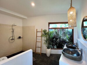 A modern bathroom with a shower, a wooden ladder, a large window with a view of greenery, and a stone sink. - Casa Carolina Bali - Great 3 Bdr - Tumbak Bayuh Canggu (Canggu)