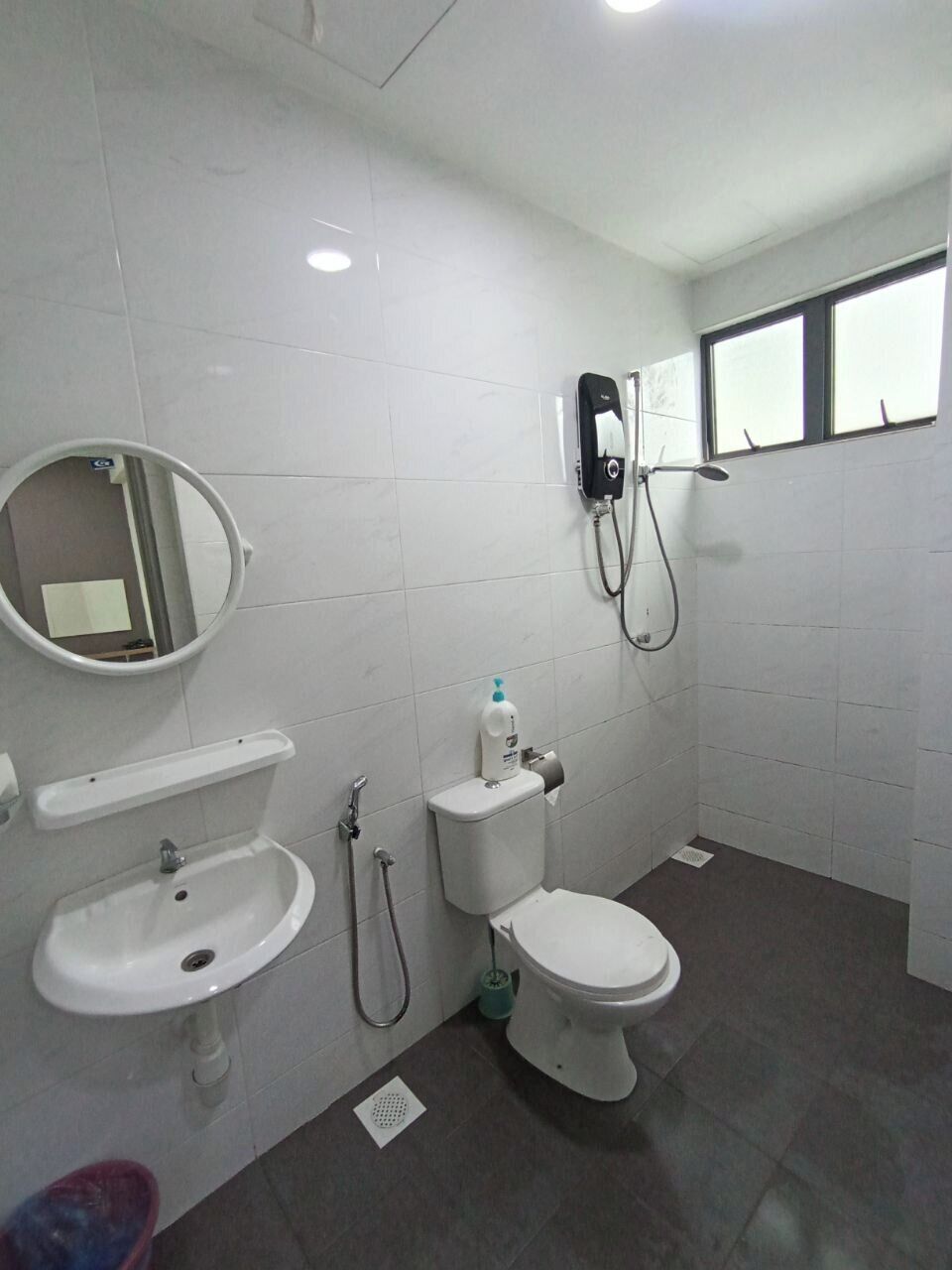 A bathroom with a sink, toilet, and shower.