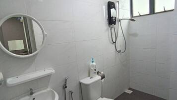 A bathroom with a sink, toilet, and shower.