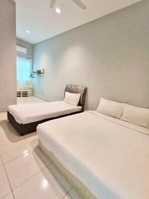 A modern hotel room with two single beds, a small desk, and a window with curtains. - Animation Homes I Meru Raya IPOH I by Grab A Stay l 16pax max (Ipoh)