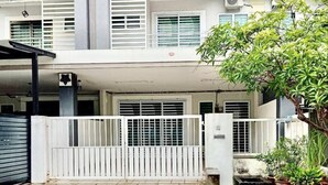 A two-story residential building with a flat roof, white exterior walls, and multiple windows with white shutters. - Animation Homes I Meru Raya IPOH I by Grab A Stay l 16pax max (Ipoh)