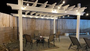 An outdoor patio with a pergola, seating, and a fire pit. - Awesome Pool House in the Kern River Valley (Wofford Heights)