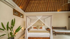 A four-poster bed with a canopy, a bedside table, a bench, and a potted plant. - Kembali On The River by Balipras (Cepaka)