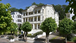Un immeuble à plusieurs étages de style architectural classique, doté d’un balcon et d’une enseigne indiquant l’année 1912.