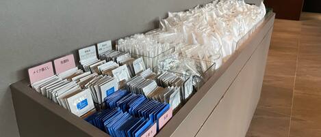 A storage unit with neatly organized folders and labeled cards, likely for guest use.