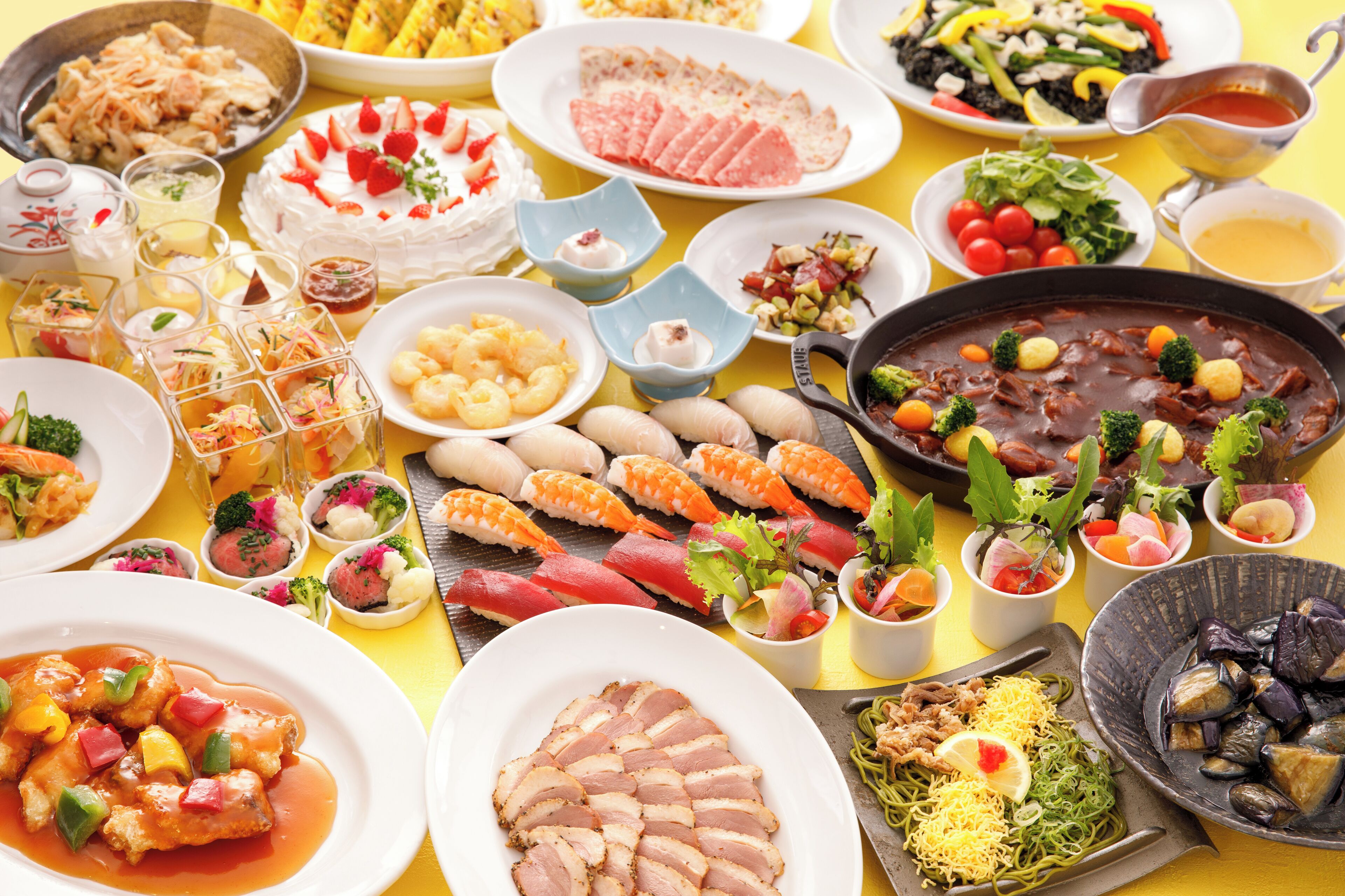 A variety of dishes including sushi, sashimi, and a large pot of stew, suggesting a diverse culinary experience.
