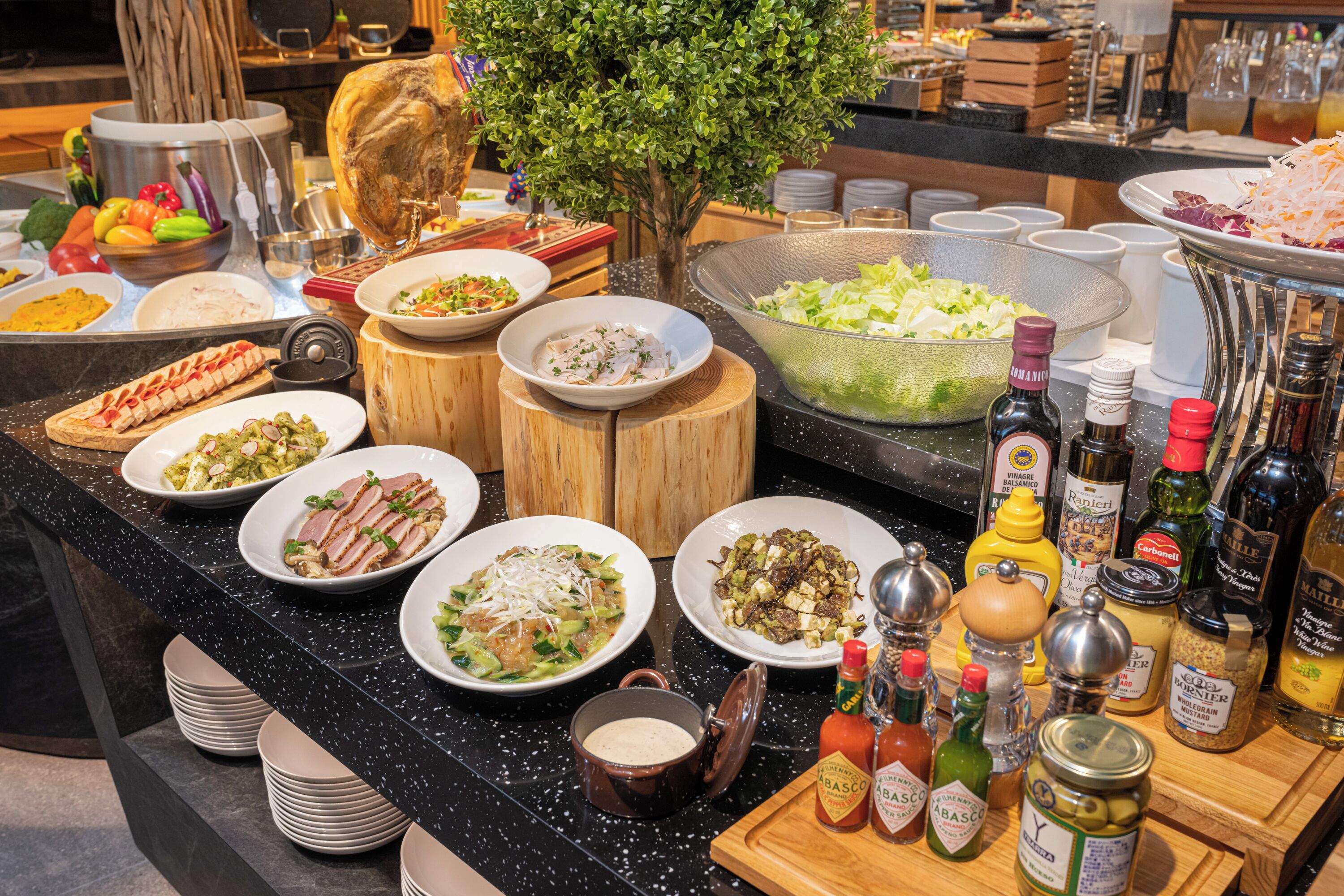 A buffet with various dishes and condiments.