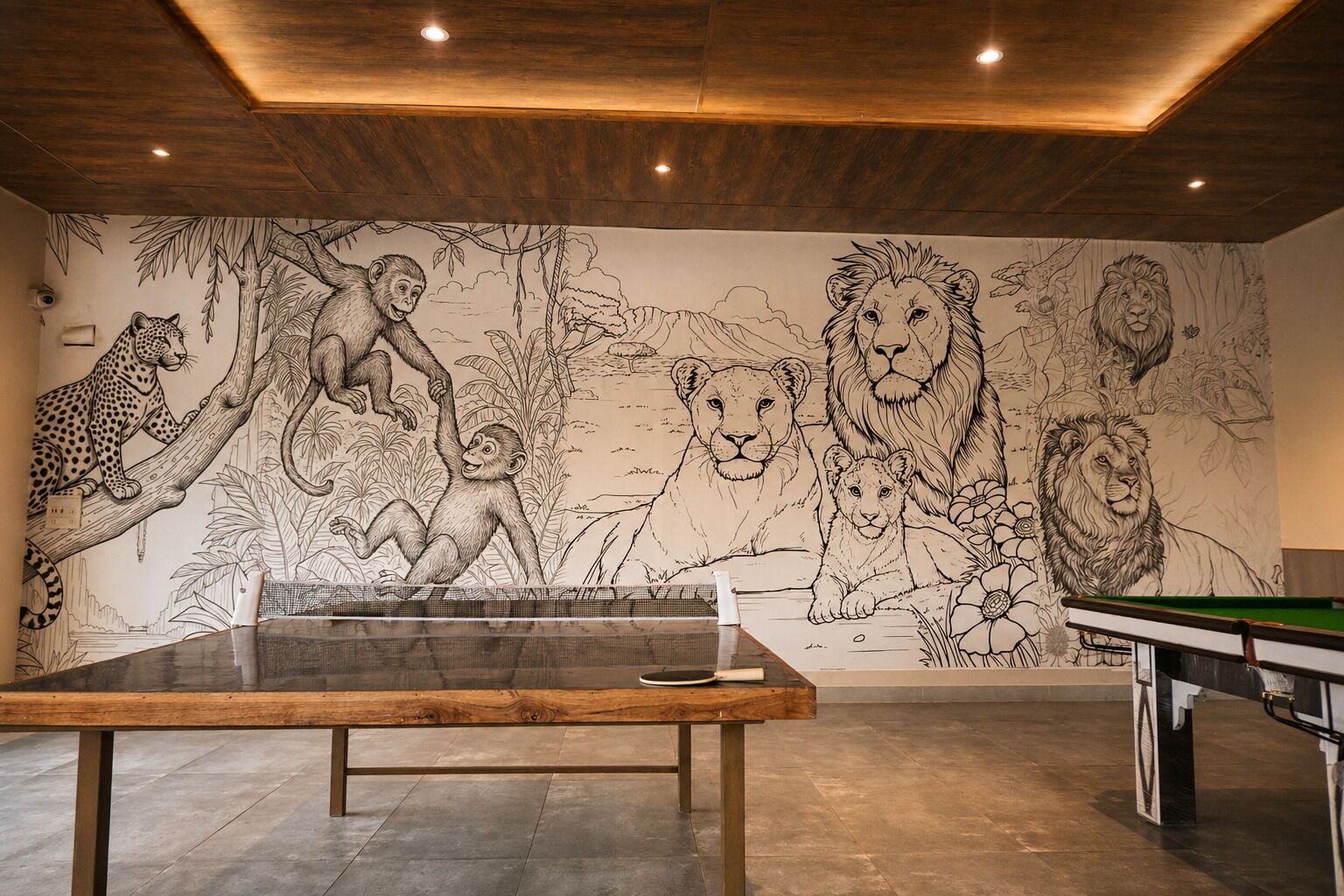 A billiards table in a room with a mural of wild animals on the wall.