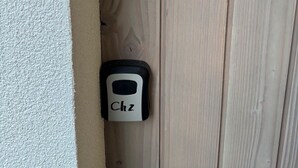 Two intercoms labeled 'Ch1' and 'Ch2' mounted on a wooden door.