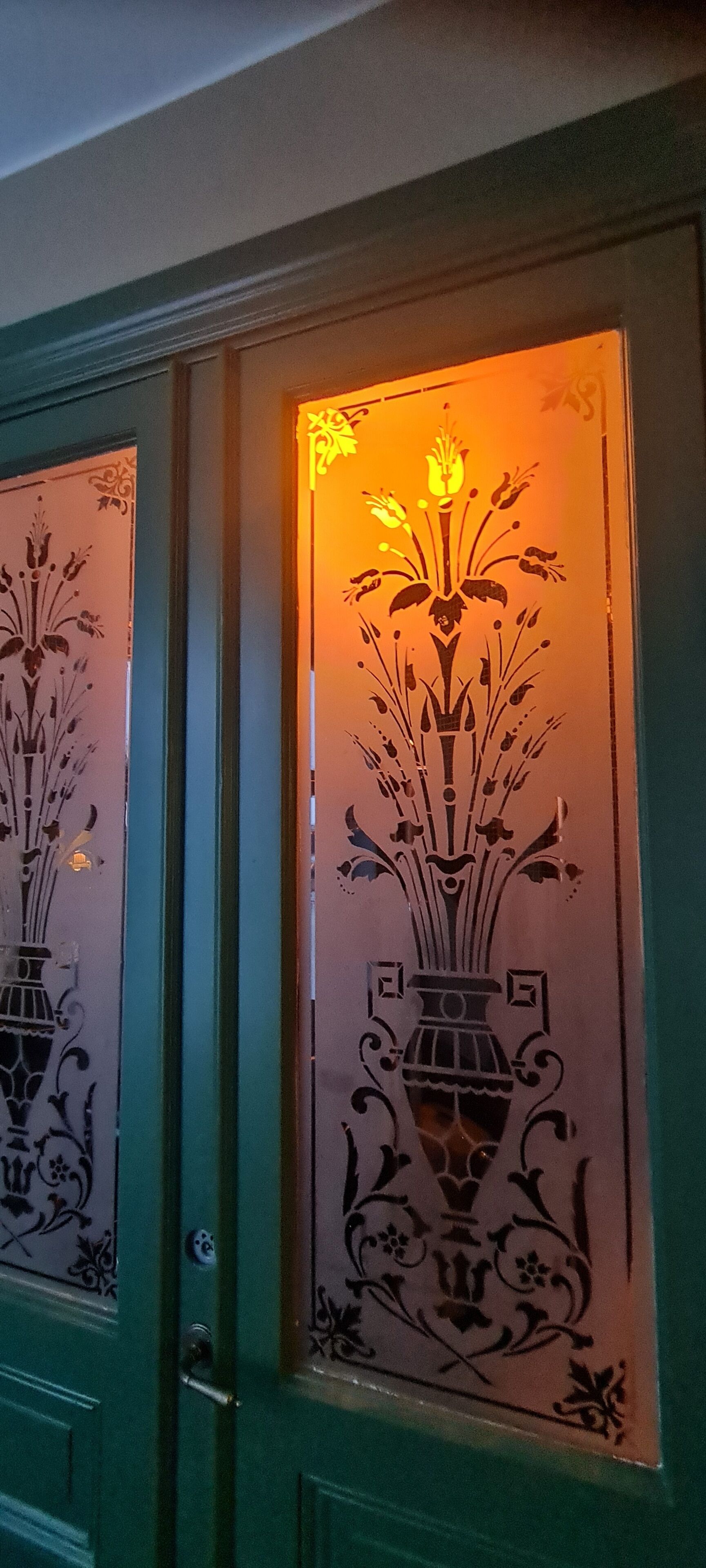 A door with intricate floral designs and a keyhole.