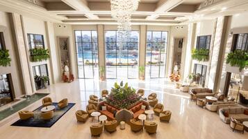 A spacious lobby with a central seating area, large windows, and a fountain.