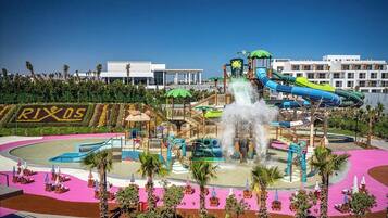 A water park with a large water slide, a splash pad, and a pool area.
