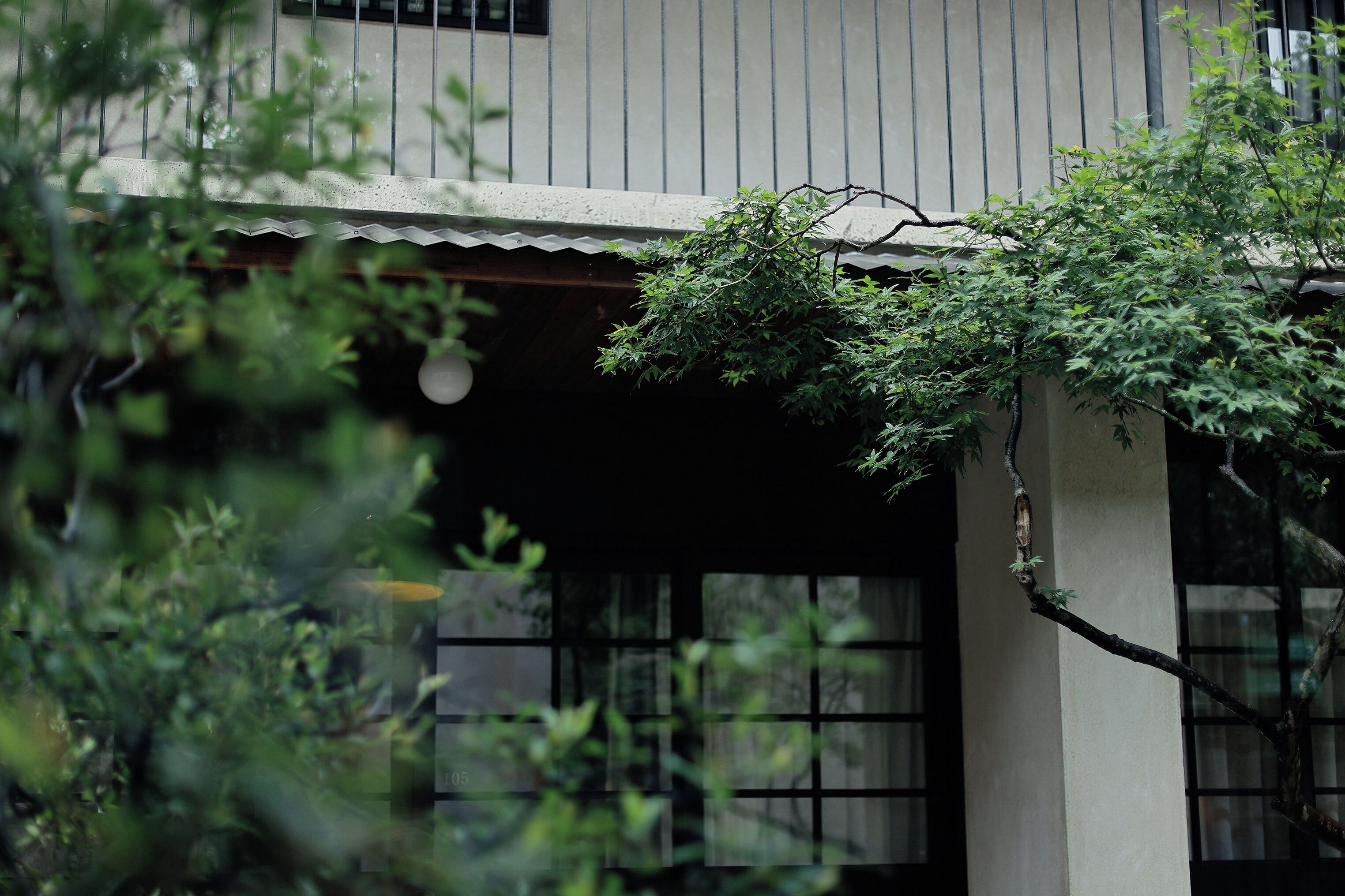 A traditional building with a tiled roof and a window with a grid pattern.