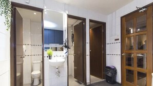 A modern bathroom with a toilet, sink, and shower area. - Hotel O Senja Hostel Chinatown (Kuala Lumpur)