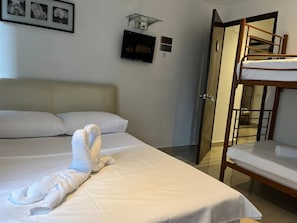 A hotel room with a bed, a TV, a door, and a bunk bed. - Hotel O Senja Hostel Chinatown (Kuala Lumpur)