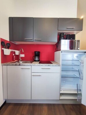 Fridge, microwave, cookware/dishes/utensils, dining tables