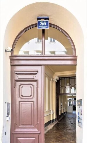 Enter through the classic arched doorway into a welcoming space.