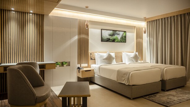 A modern hotel room with a large bed, a desk, and a chair. - HOTEL LAKE VIEW (Baharampur)