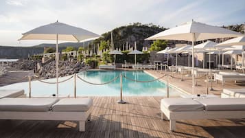 Seasonal outdoor pool, open 8:00 AM to 8:00 PM, pool umbrellas
