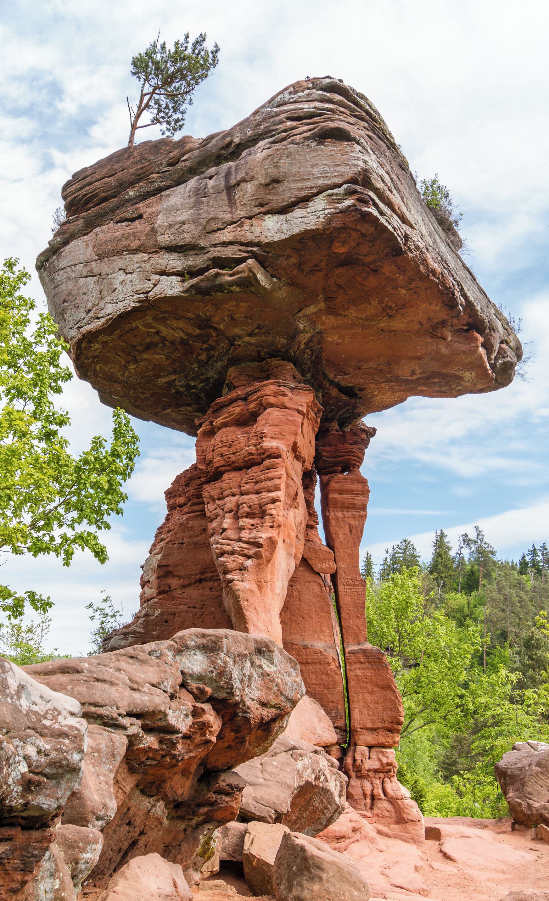 A natural rock formation with a balanced rock atop a column.