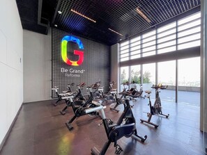 Work out in style with our state-of-the-art gym, featuring rows of stationary bikes and a high ceiling.
