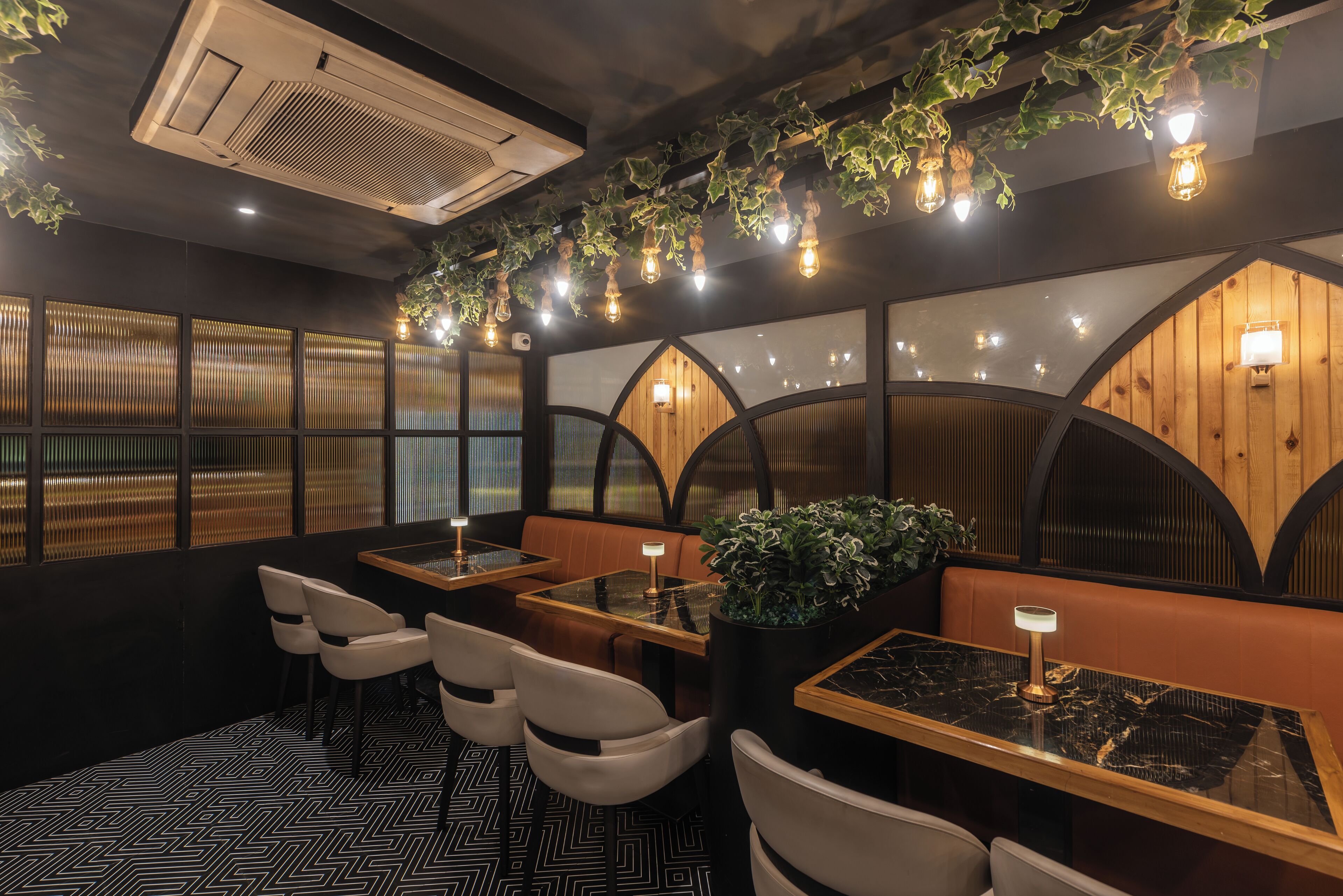 A restaurant interior with booths, tables, and a patterned floor.
