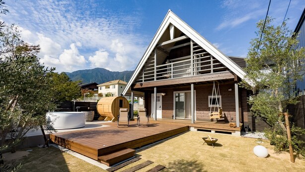 A modern house with a wooden deck, a hot tub, and a swing chair. - IZA oumimaiko (Otsu)