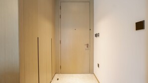 A narrow hallway with a wooden door at the end. - Zapbed House - ADP 2108 (Dubai)