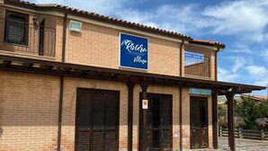 A building with a sign reading "Riviera Village". - Riviera Village (Butera)