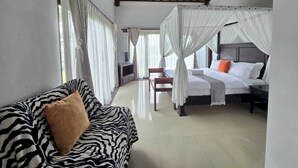 A bedroom with a bed, a sofa, and a TV. - Belvilla Bunga Matahari Ceking Rice Terrace (Taro)