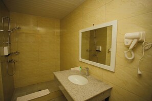 A bathroom with a sink, mirror, and hairdryer. - Haile Hotel Wolaita (Soddu)