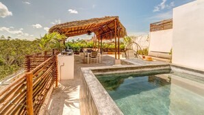 A rooftop pool area with a wooden pergola, outdoor seating, and a clear view of the surrounding landscape. - Splendid Penthouse, Rooftop Plunge Pool, 2 Cenotes (Tulum)