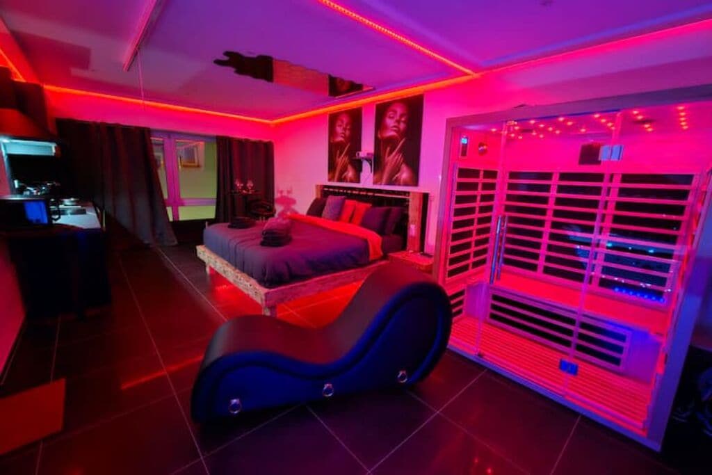 Een slaapkamer met een bed, een stoel en een verwarming.