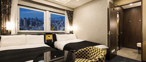 A hotel room with two beds, a small table, a chair, a city view, and a door.