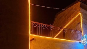 A building with a neon-lit archway and a blue sign with a lion emblem. - King Solomon Palace  (Avanos)