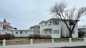 A row of white residential buildings with a white fence in the foreground. - Nordurgata 43 (Akureyri)