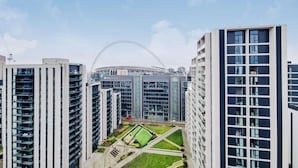 A high-rise building with a modern architectural design, featuring multiple floors with balconies. - Your London Escape Luxurious 1 Bedroom Apartment (Wembley)