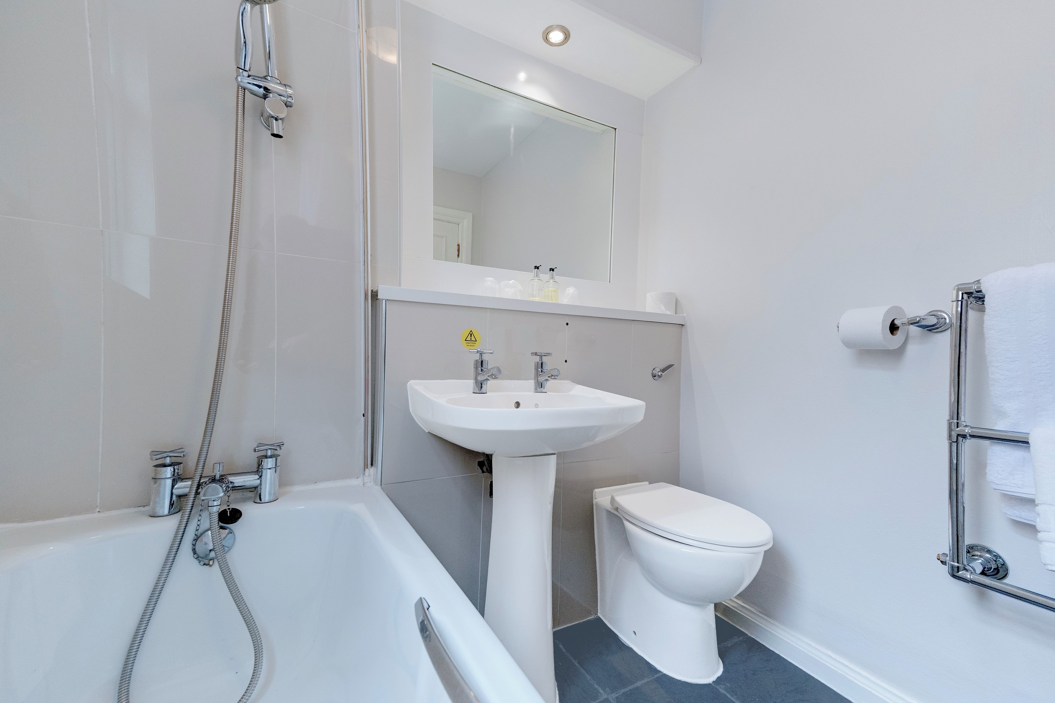A bathroom with a bathtub, a sink, and a toilet.
