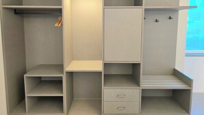 A walk-in closet with multiple shelves, drawers, and hanging space. - A&A Rooms (Anacapri)