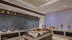 A buffet setup with various food items and a coffee station. - Regenta Place Gwalior (Gwalior)