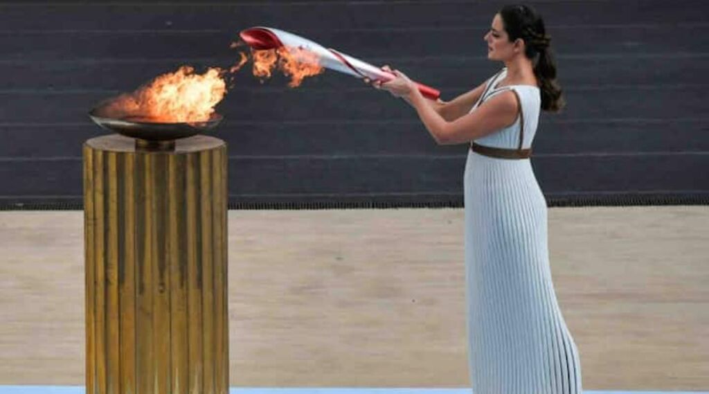 A woman performing with a flaming torch.