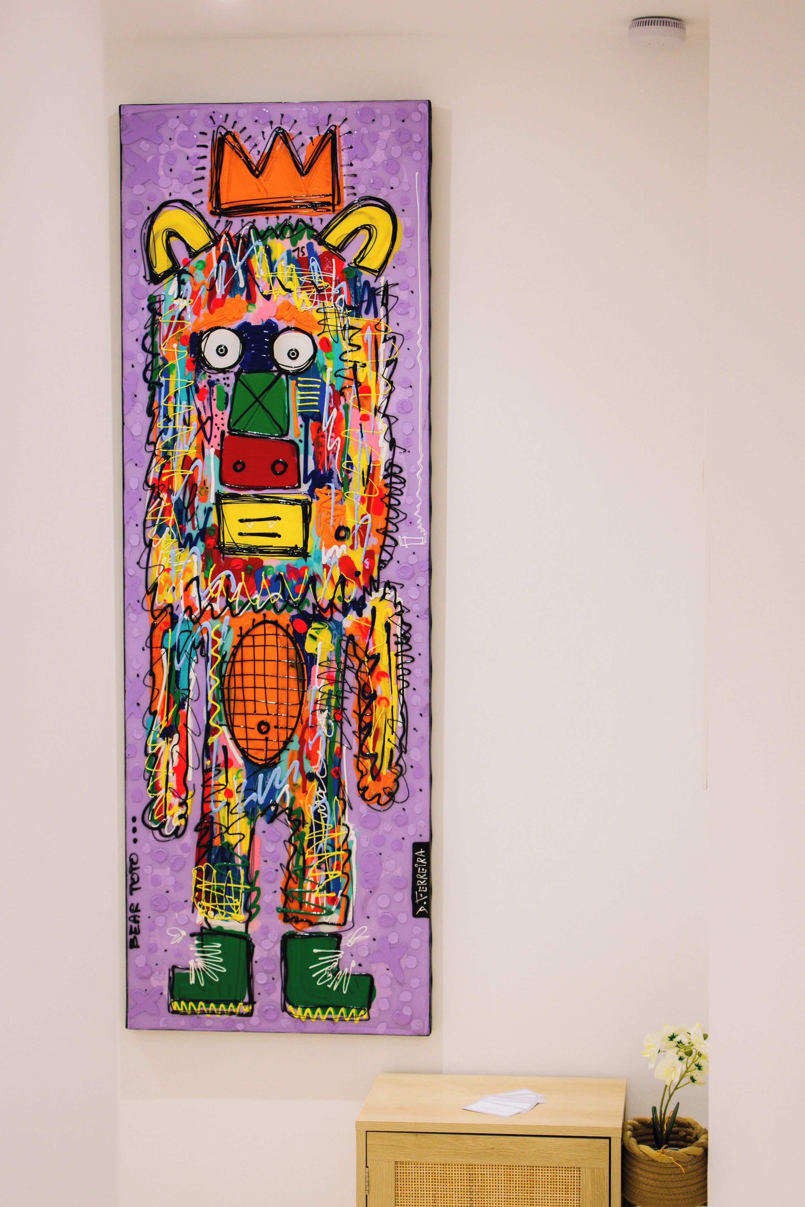 A colorful abstract painting on a wall.