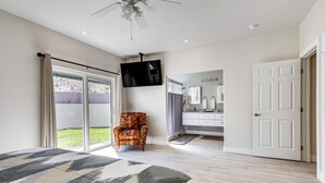A bedroom with a large bed, a TV mounted on the wall, and a sliding glass door leading to a balcony. - Spacious Mesquite Getaway - 1/2 Mi to Golf Course (Mesquite)