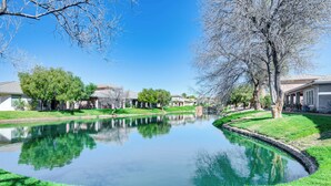 A serene residential area with a pond reflecting trees and houses. - Spacious Mesquite Getaway - 1/2 Mi to Golf Course (Mesquite)