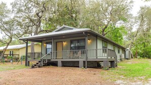 A two-story house with a porch, a staircase, and a covered front porch area. - Lakefront Keystone Heights Cottage w/ Private Dock (Keystone Heights)