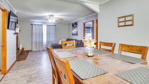A dining area with a wooden table, chairs, and a ceiling fan. - Quiet & Cozy Rembert Home ~ 9 Mi to Air Force Base (Rembert)