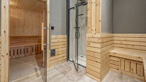 A sauna room with wooden benches and a glass-enclosed shower area. - Lodge No 10 | St Andrews Lodge Park (Strathkinness)